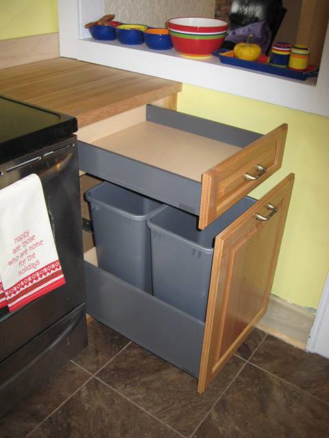 Garbage pull out and cutlery storage.