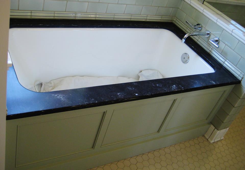 Painted maple beaded inset panel along with the solid surface surround gives this inset bathtub a nice classical feel