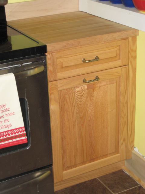 Red Oak kitchen cabinets with clear finish. The hard maple butcher block makes a nice work service.