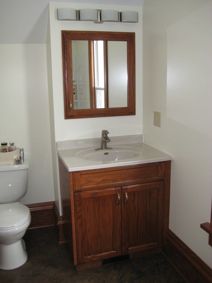 Red oak bathroom vanity with matching medicine cabinet