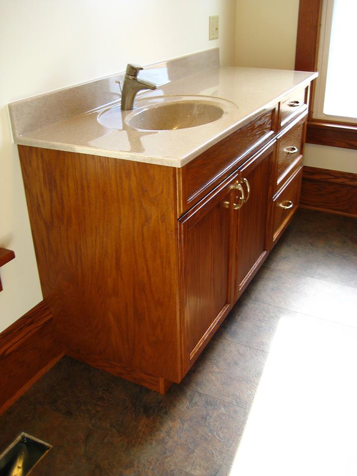 Red oak vanity finished to match the vintage wood work of the home.